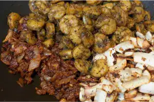 Roasted prawns combined with masala and fried coconut for authentic chemeen varattiyathu.