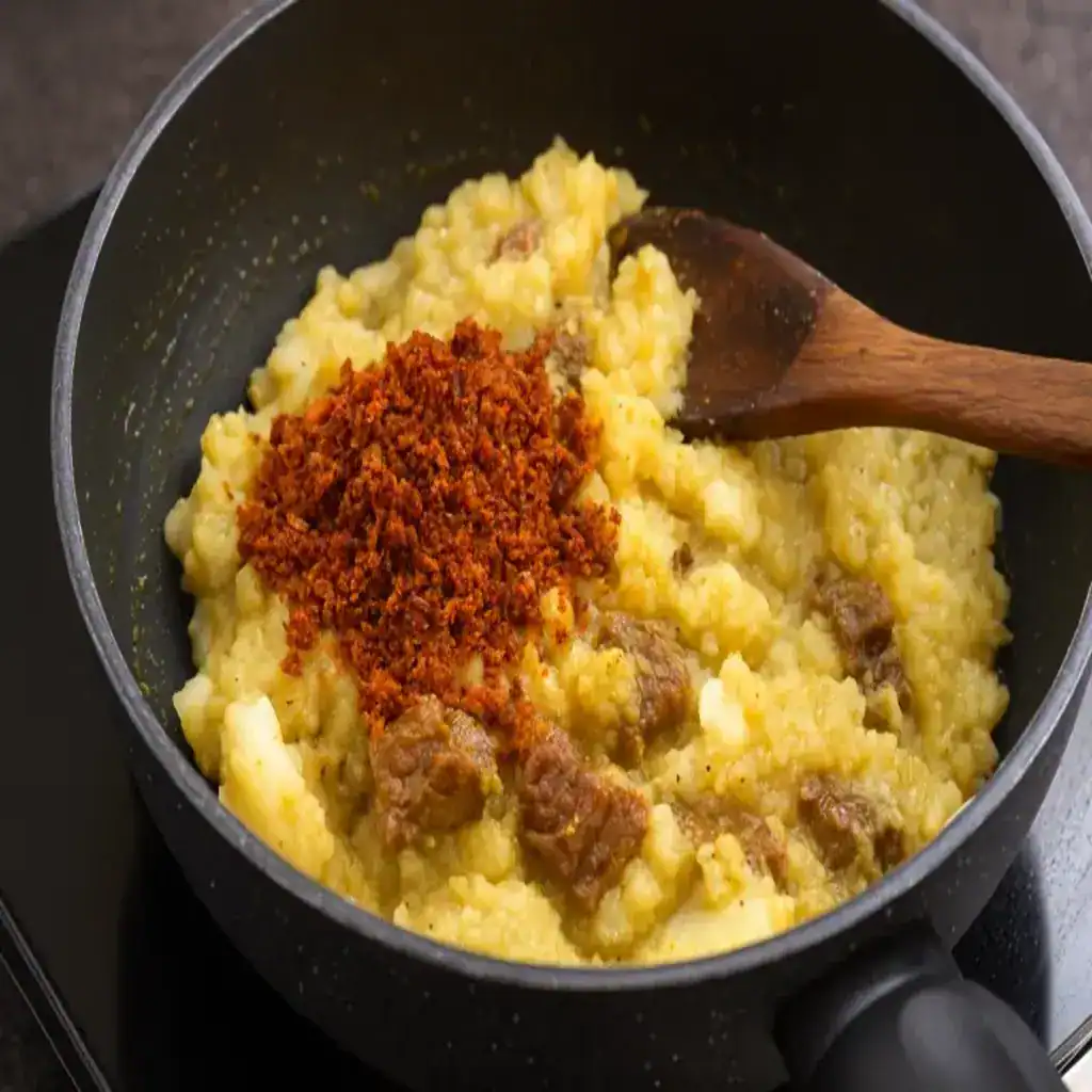 Mashed tapioca and beef cooked with roasted coconut masala for Kerala style Kappa Biriyani.
