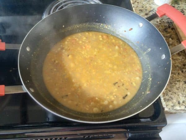Kerala style green peas masala curry simmering in a kadai until gravy thickens.