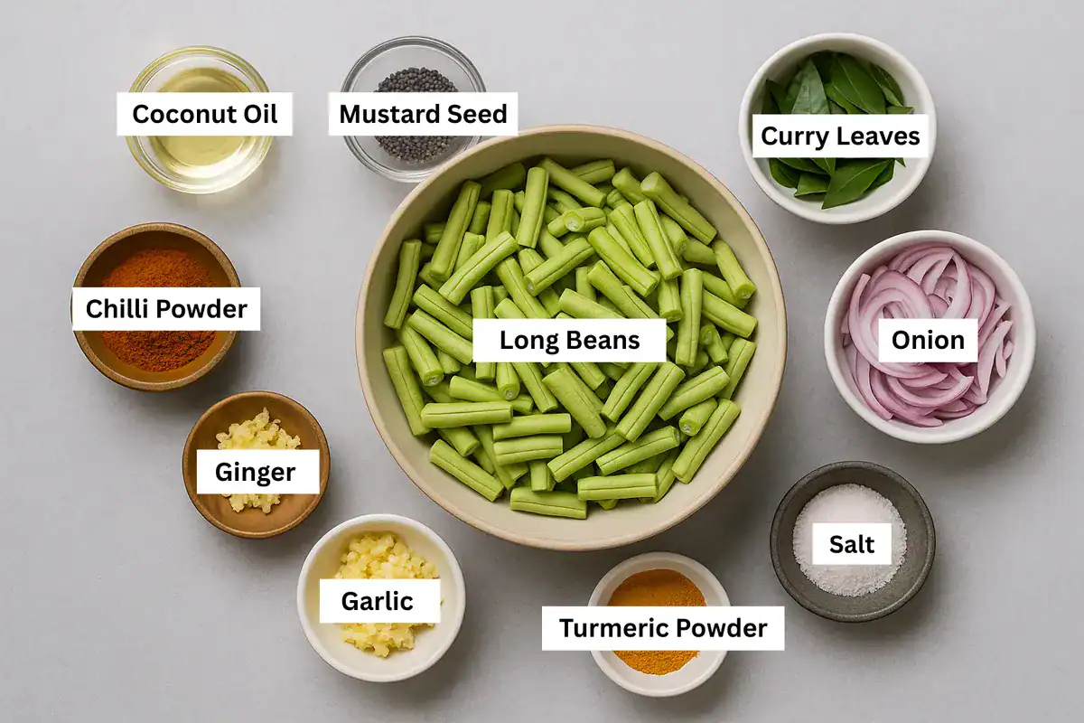 All ingredients for Achinga Payar Mezhukkupuratti in separate bowls on a gray background, including beans, onion, spices, and oil.