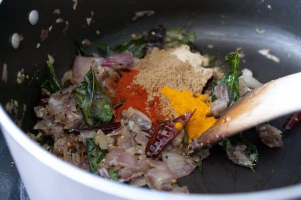 Chopped onion, garlic, curry leaves, and spice powders sautéed in oil to make the masala base for Kerala sambar.