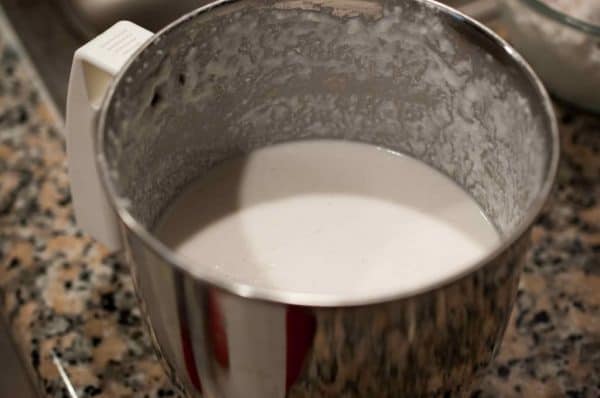 Raw rice, boiled rice, and grated coconut added to a mixer jar and ground for Appam.