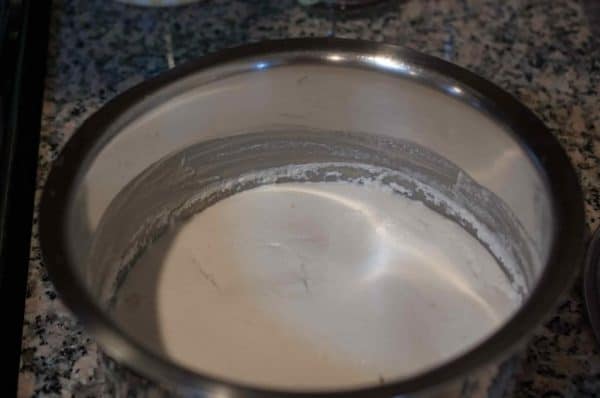 Fermented appam batter risen and foamy in a steel bowl after overnight resting.