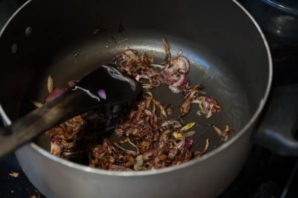 Onions fried in ghee until golden brown, prepared as garnish for Kerala Ney Choru.