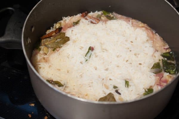 Ney Choru resting after cooking, water absorbed, rice soft and aromatic with whole spices.