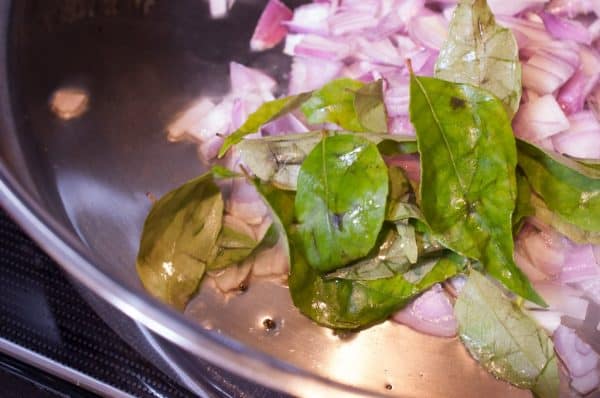 Mustard seeds spluttered in coconut oil, followed by shallots and curry leaves for Cherupayar Thoran tempering.

