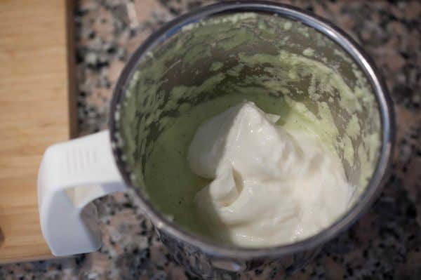 Thick yogurt added to coconut paste in a mixer jar for Kerala Vendakka Kichadi.