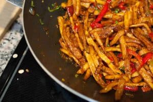 Honey Chilli Potato is a popular Indo-Chinese appetizer. Crispy Fried Potatoes cooked with spring onion and bell peppers in a sweet and spicy sauce.