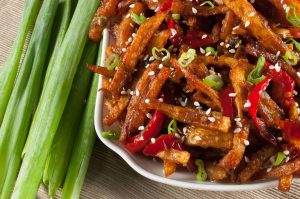 Honey Chilli Potato is a popular Indo-Chinese appetizer. Crispy Fried Potatoes cooked with spring onion and bell peppers in a sweet and spicy sauce.