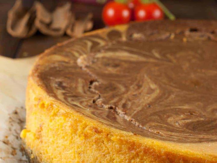 Pumpkin chocolate swirl cheesecake with oreo crust which is rich, delicious and has an amazing pumpkin pie spice flavor. Melted Chocolate chips swirled into pumpkin cheesecake mixture gives it a marbled effect.
