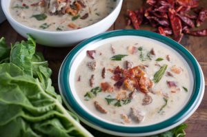 Spicy Italian sausage, fresh leaves, and potatoes in a creamy broth topped with crumbled bacon. An easy and yummy Olive Garden Zuppa Toscana Soup recipe.