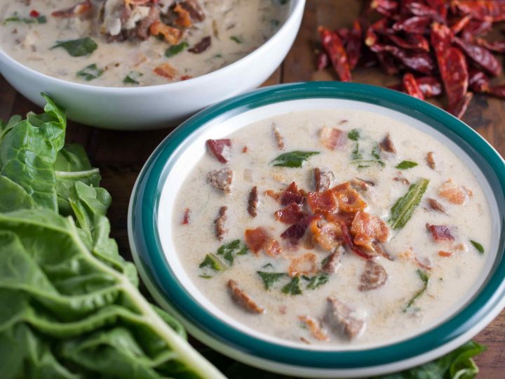 Spicy Italian sausage, fresh leaves, and potatoes in a creamy broth topped with crumbled bacon. An easy and yummy Olive Garden Zuppa Toscana Soup recipe.