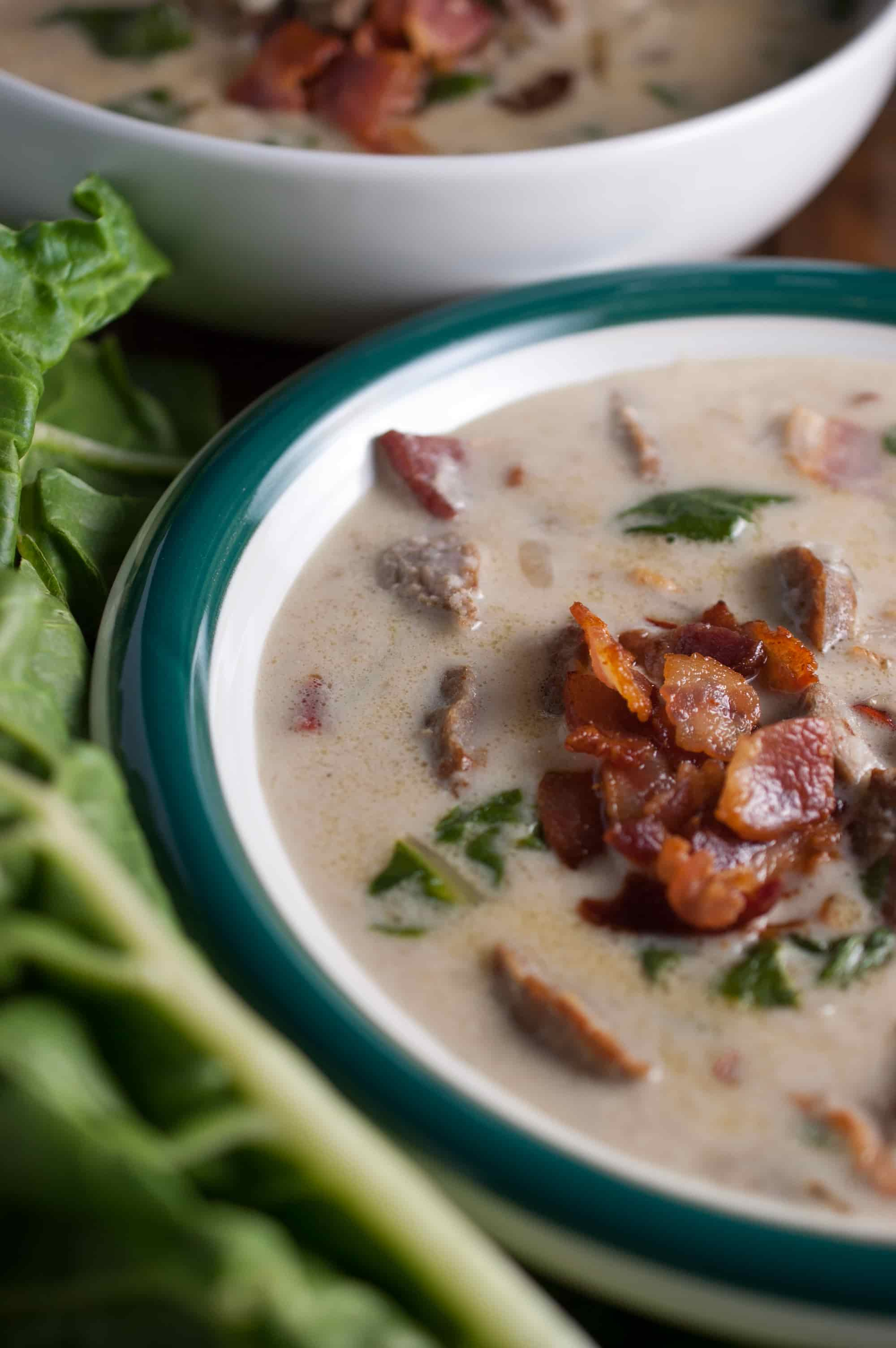 Spicy Italian sausage, fresh leaves, and potatoes in a creamy broth topped with crumbled bacon. An easy and yummy Olive Garden Zuppa Toscana Soup recipe.