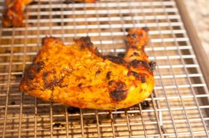 Chicken marinated in yogurt and spices and then baked in an oven. This Indian Tandoori Chicken In Oven recipe is straightforward to make at home with minimal ingredients