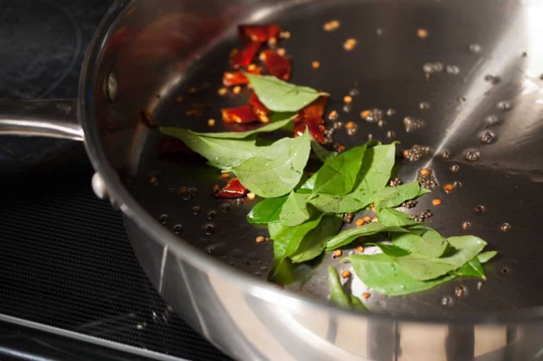 Kerala style beans stir fry with spices, ginger, and garlic. This Beans Mezhukkupuratti or Beans Olathiyathu is a quick and healthy side dish that goes well with rice.