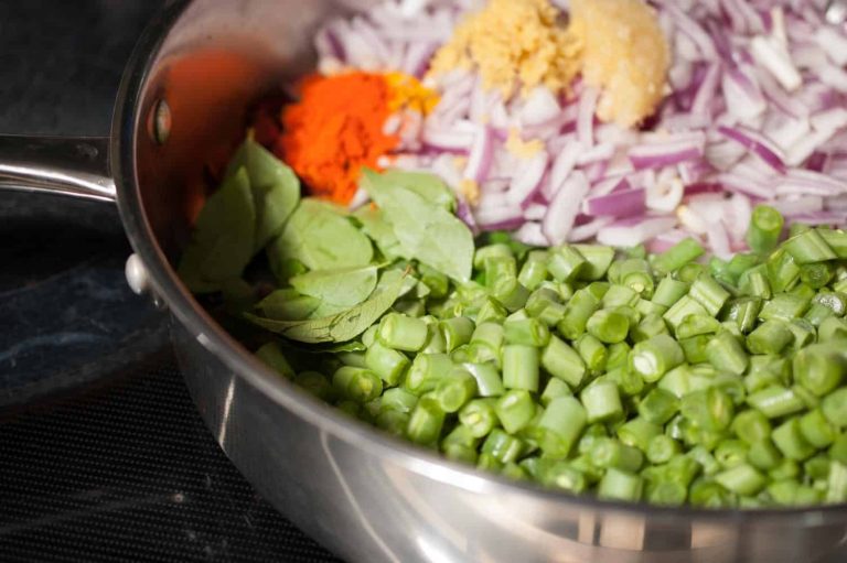 Kerala style beans stir fry with spices, ginger, and garlic. This Beans Mezhukkupuratti or Beans Olathiyathu is a quick and healthy side dish that goes well with rice.