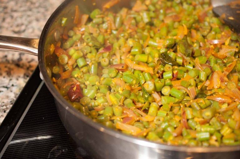 Kerala style beans stir fry with spices, ginger, and garlic. This Beans Mezhukkupuratti or Beans Olathiyathu is a quick and healthy side dish that goes well with rice.