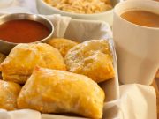 This is an image of indian chicken puffs with tea on the side, ketchup as dipping and some tapioca chips