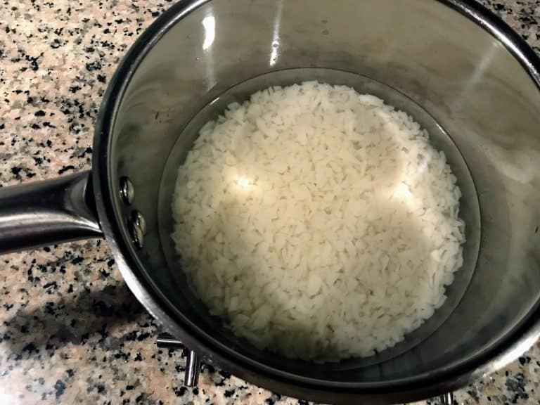 Wash and drain the rice ada. Place the drained rice ada in a bowl and fill it up with enough hot boiling water.
