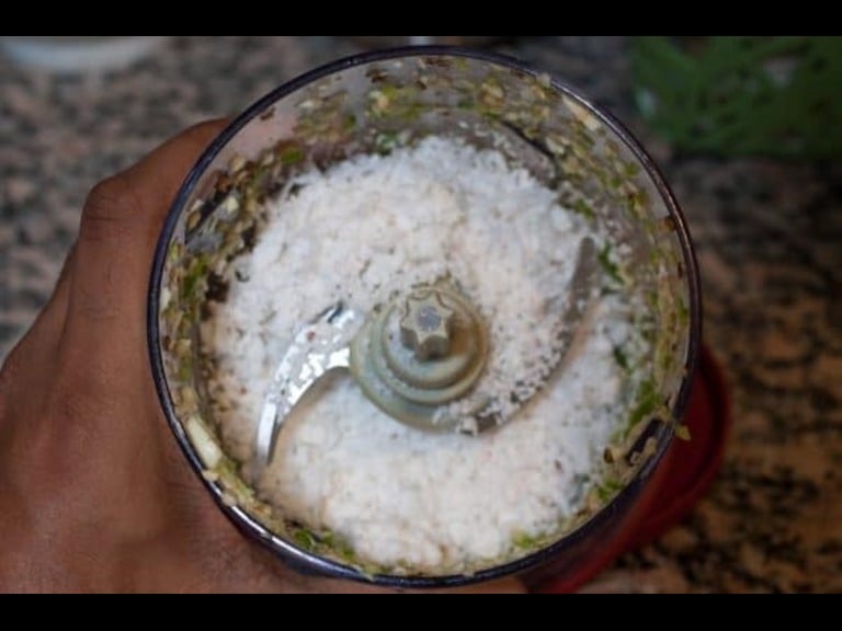 Coarse coconut mix with green chilli, cumin, and shallots ground in a blender for Kerala Avial.