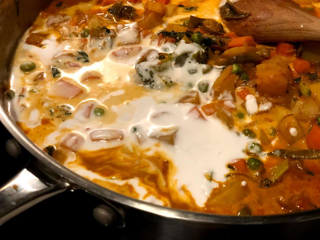 Adding thick coconut milk into the gravy