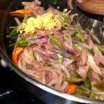 Adding ginger and garlic into sauteed onion, green chilly and curry leaves.