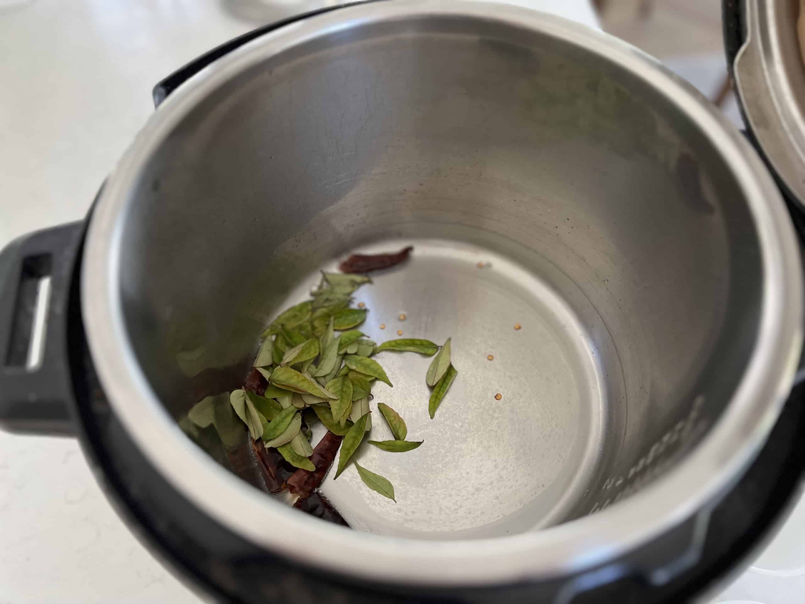 Fry dry red chillies and curry leaves in coconut oil