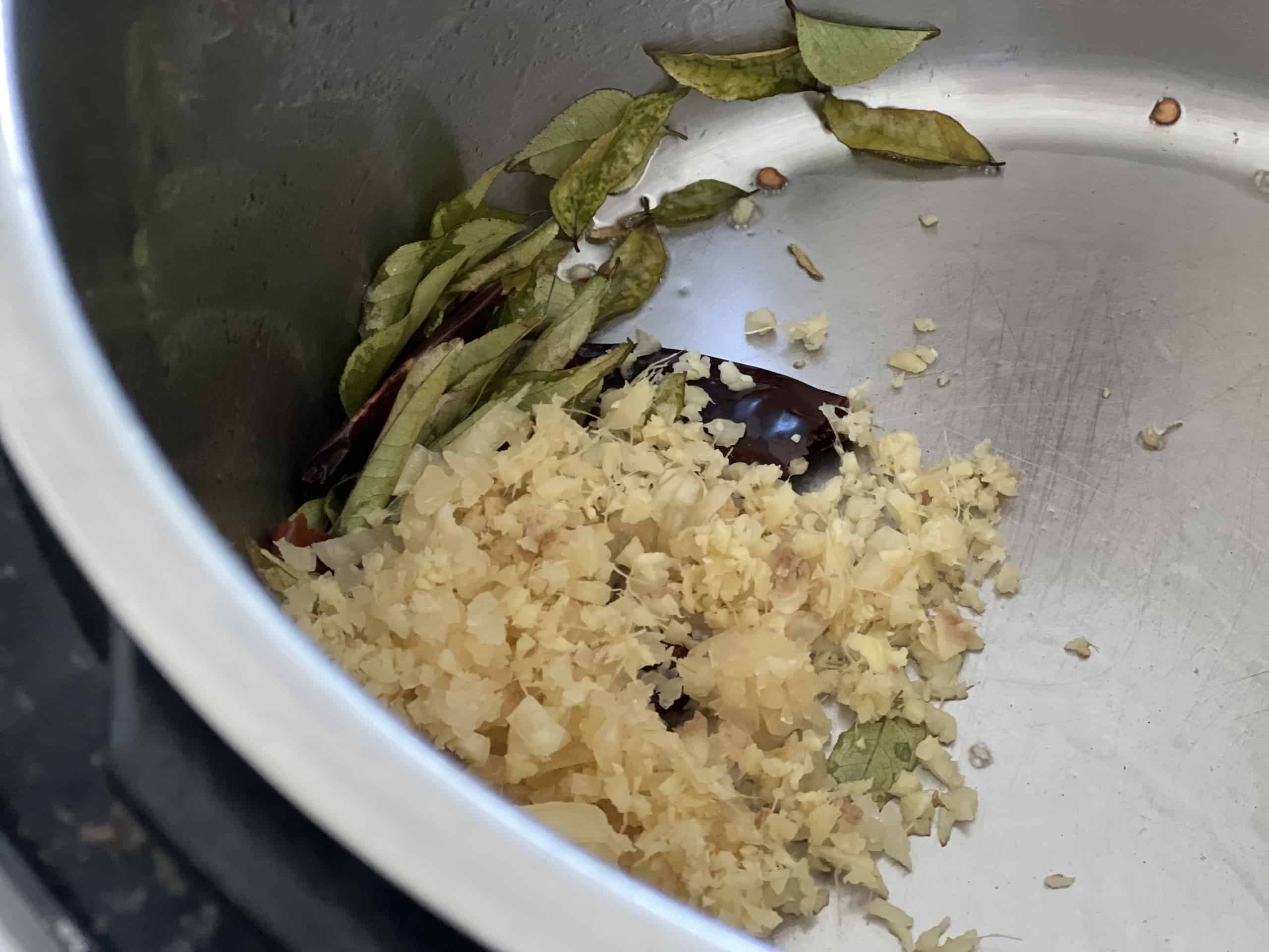 Fry chopped ginger and garlic in coconut oil