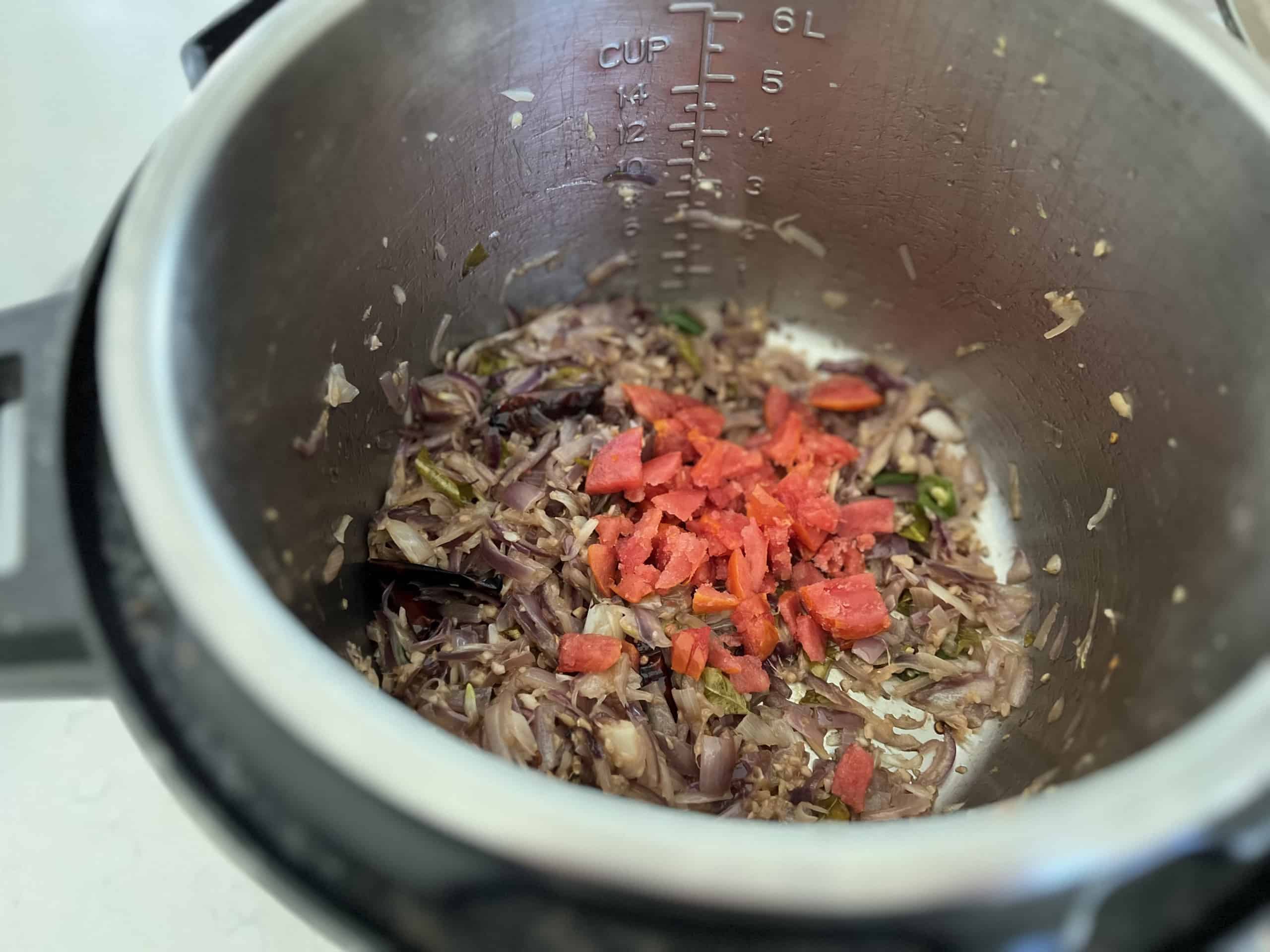 Add and cook sliced tomato in the gravy